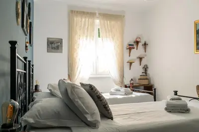 two beds in a bedroom with a window at Casa Nanna Chic in Vatican in Rome