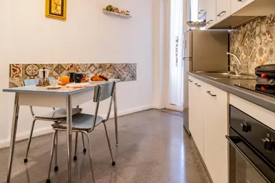 a kitchen with a table and chairs in a kitchen at Casa Nanna Chic in Vatican in Rome