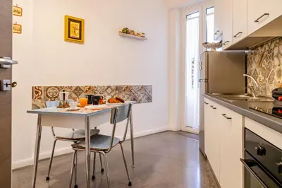 a kitchen with a table and a refrigerator at Casa Nanna Chic in Vatican in Rome