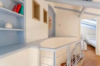 a kitchen with a counter in a room at iFlat Vatican New & Comfy Sunlit Apartment in Rome