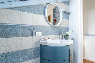 a bathroom with a sink and a mirror at iFlat Vatican New & Comfy Sunlit Apartment in Rome
