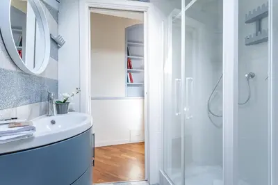 a white bathroom with a shower and a sink at iFlat Vatican New & Comfy Sunlit Apartment in Rome