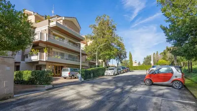 a small red and white car parked in front of a building at Vatican Park Residence in Rome