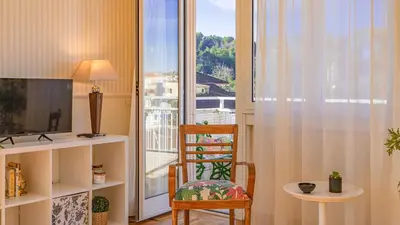 a living room with a chair and a window at Vatican Park Residence in Rome