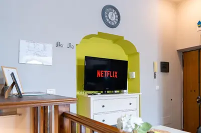 a living room with a tv on top of a dresser at Loft16 Rome - 10 min PlGNETO - COLOSSEO in Rome
