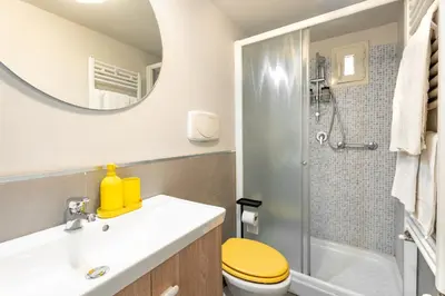 a bathroom with a toilet and a sink and a mirror at Loft16 Rome - 10 min PlGNETO - COLOSSEO in Rome