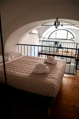 a bedroom with a bed with two towels on it at Loft in Rhome in Rome