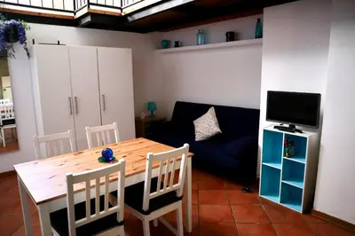 a living room with a table and a couch at Loft in Rhome in Rome