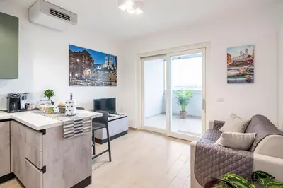 an apartment with a kitchen and a living room at Brand new apartment with private parking space in Rome