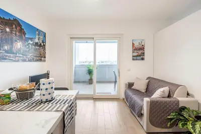 a living room with a couch and a table at Brand new apartment with private parking space in Rome