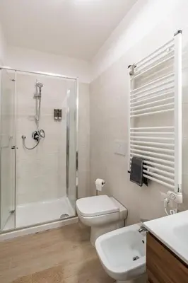 a bathroom with a shower and a toilet and a sink at Brand new apartment with private parking space in Rome