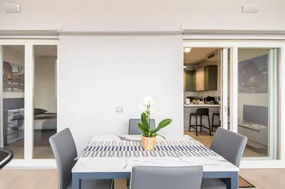 a dining room with a table and chairs at Brand new apartment with private parking space in Rome