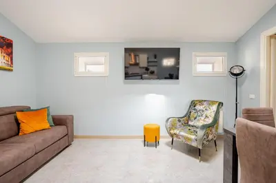 a living room with a couch and a chair at Blue Sky Apartment - 5 min Vatican in Rome