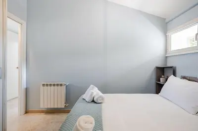 a bedroom with a bed with towels on it at Blue Sky Apartment - 5 min Vatican in Rome