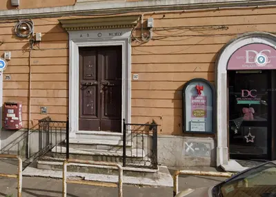 a building with a brown door and a window at Blue Sky Apartment - 5 min Vatican in Rome
