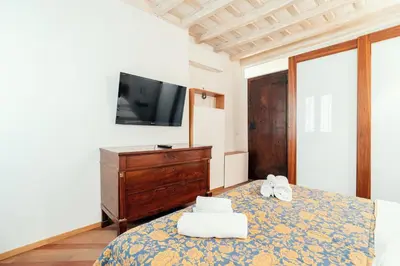 a bedroom with a bed with two towels on it at Majorelle comfy apartment in Rome