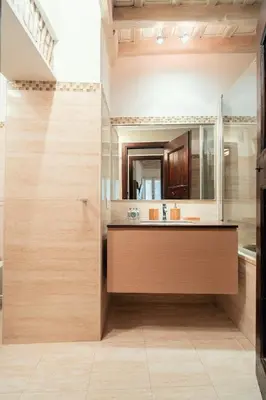 a view of a bathroom through a doorway at Majorelle comfy apartment in Rome