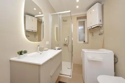 a bathroom with a sink and a toilet and a mirror at Charm Apartment San Giovanni in Rome