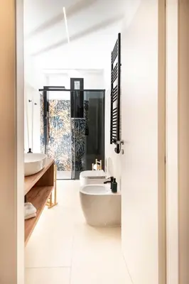 a bathroom with two sinks and a tub at Casa Gazometro in Rome