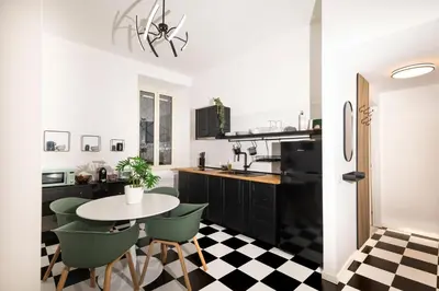 a kitchen with a black and white checkered floor at Casa Gazometro in Rome
