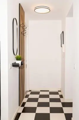 a hallway with a black and white checkered floor at Casa Gazometro in Rome