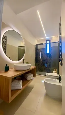 a bathroom with two sinks and a large mirror at Casa Gazometro in Rome