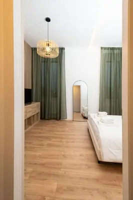 a bedroom with a bed and a chandelier at Casa Gazometro in Rome