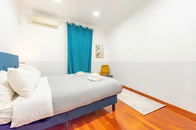 a bedroom with a bed and a blue curtain at Domus 44 Apartment in Rome