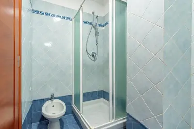a bathroom with a shower with a toilet and a sink at Domus 44 Apartment in Rome