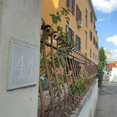 a iron fence with the number on the side of a building at Domus 44 Apartment in Rome