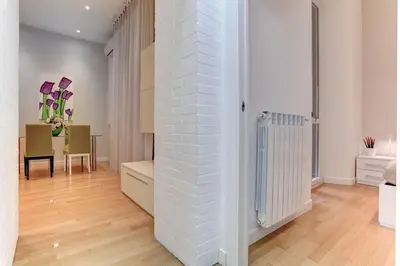 a living room with a white brick wall at Porta Pia Suite in Rome