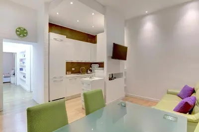 a kitchen and living room with a glass table and chairs at Porta Pia Suite in Rome