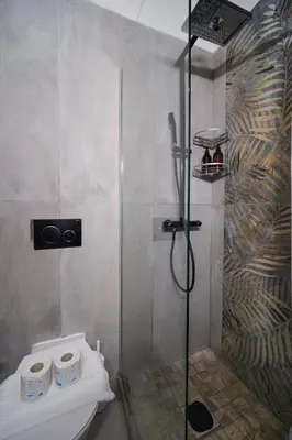 a shower with a toilet in a bathroom at Trident Suite by BuddyRent in Rome
