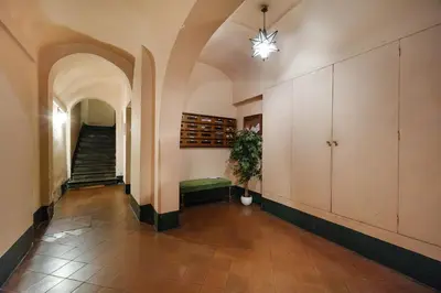 an empty hallway with a staircase and a potted plant at Trident Suite by BuddyRent in Rome