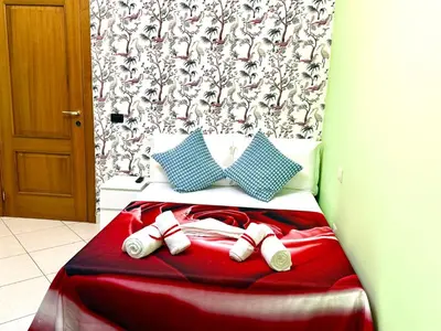 a bed with two pairs of slippers on it at Colosseum Star Guest House in Rome