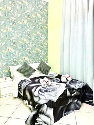 a bedroom with a bed with red bows on it at Colosseum Star Guest House in Rome