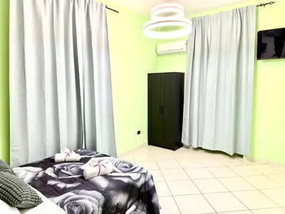 a bedroom with a bed and a black door at Colosseum Star Guest House in Rome