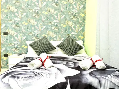 a bedroom with a bed with slippers on it at Colosseum Star Guest House in Rome