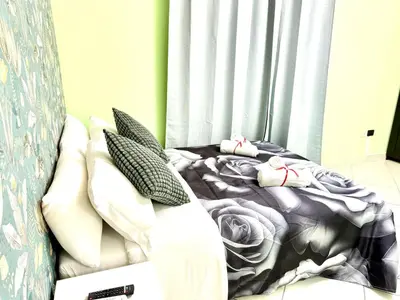 a bed with pillows on it in a room at Colosseum Star Guest House in Rome