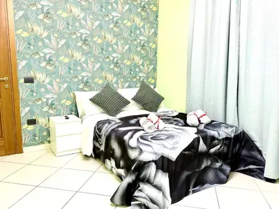 a bedroom with a bed with a black and white blanket at Colosseum Star Guest House in Rome