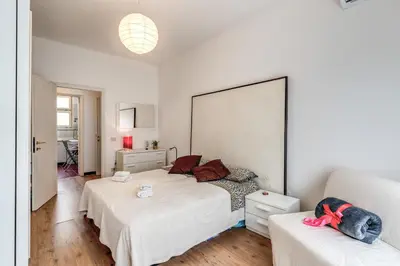 a bedroom with two beds and a large mirror at Zeus House in Rome