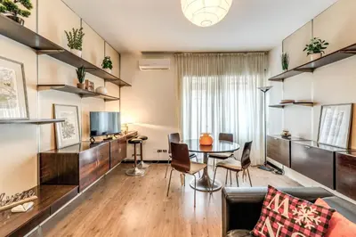 a living room with a table and chairs at Zeus House in Rome