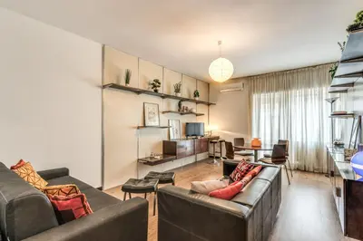 a living room with two couches and a tv at Zeus House in Rome