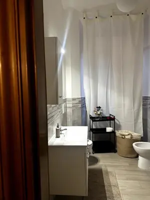 a white bathroom with a sink and a toilet at The Apartment 56 in Rome