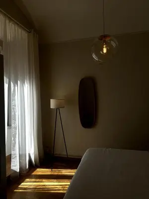 a bedroom with a bed and a lamp and a window at The Apartment 56 in Rome