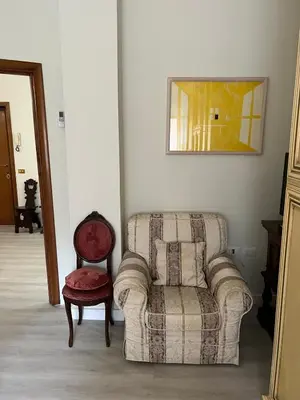 a living room with a couch and a chair at Elegant Home in Rome Appio, Wi-Fi, Subway in Rome