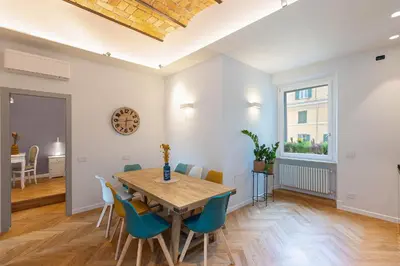a dining room with a wooden table and chairs at Dandolo Top Floor Trastevere in Rome