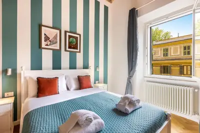 a bedroom with a bed with two towels on it at Dandolo Top Floor Trastevere in Rome
