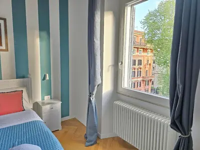 a bedroom with a window and a bed with a radiator at Dandolo Top Floor Trastevere in Rome