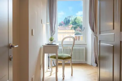 a room with a table and a chair and a window at Dandolo Top Floor Trastevere in Rome